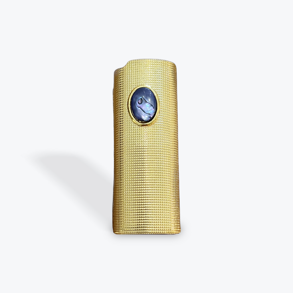 Gold textured lighter case with a bluish purple abalone stone on a white background