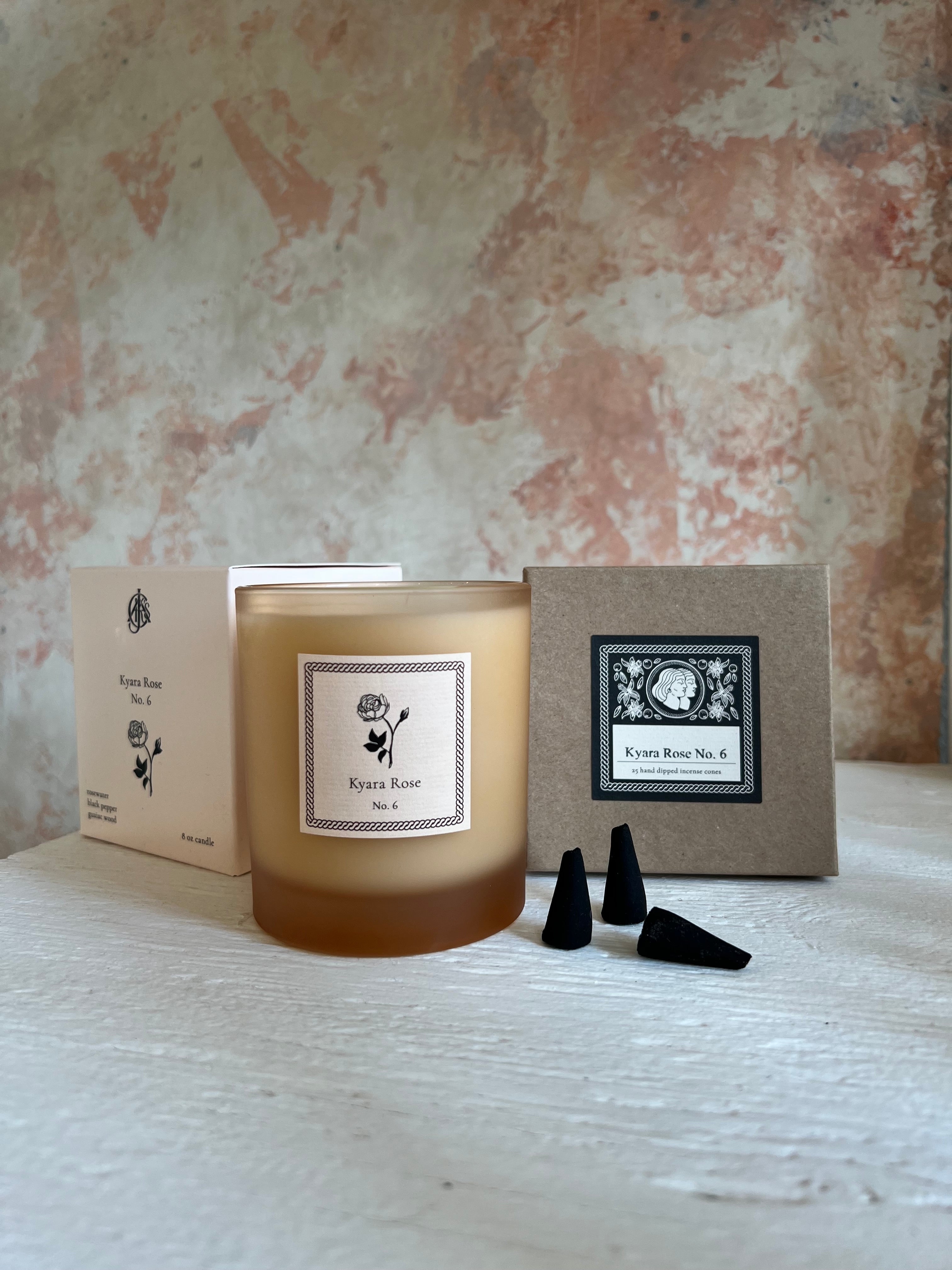 Candle and incense cones with packaging on a textured surface