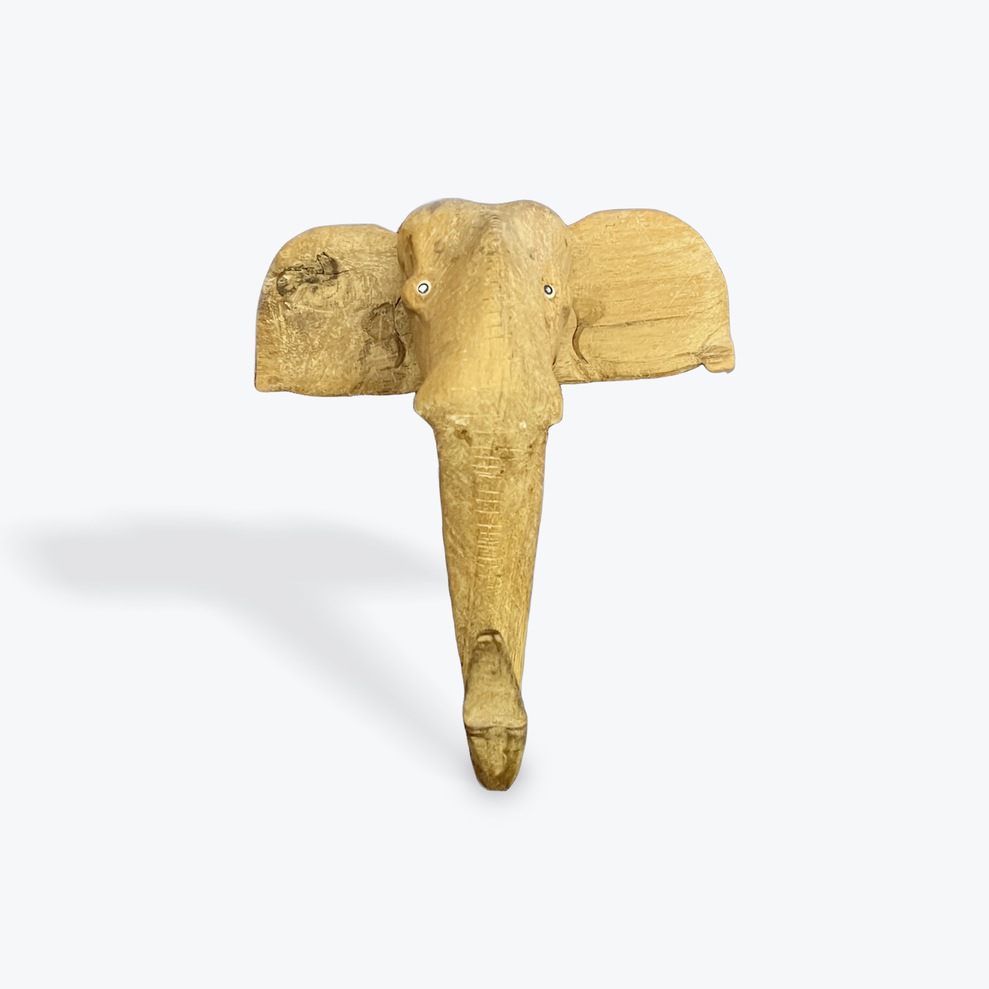 Wooden elephant head wall decoration on a white background