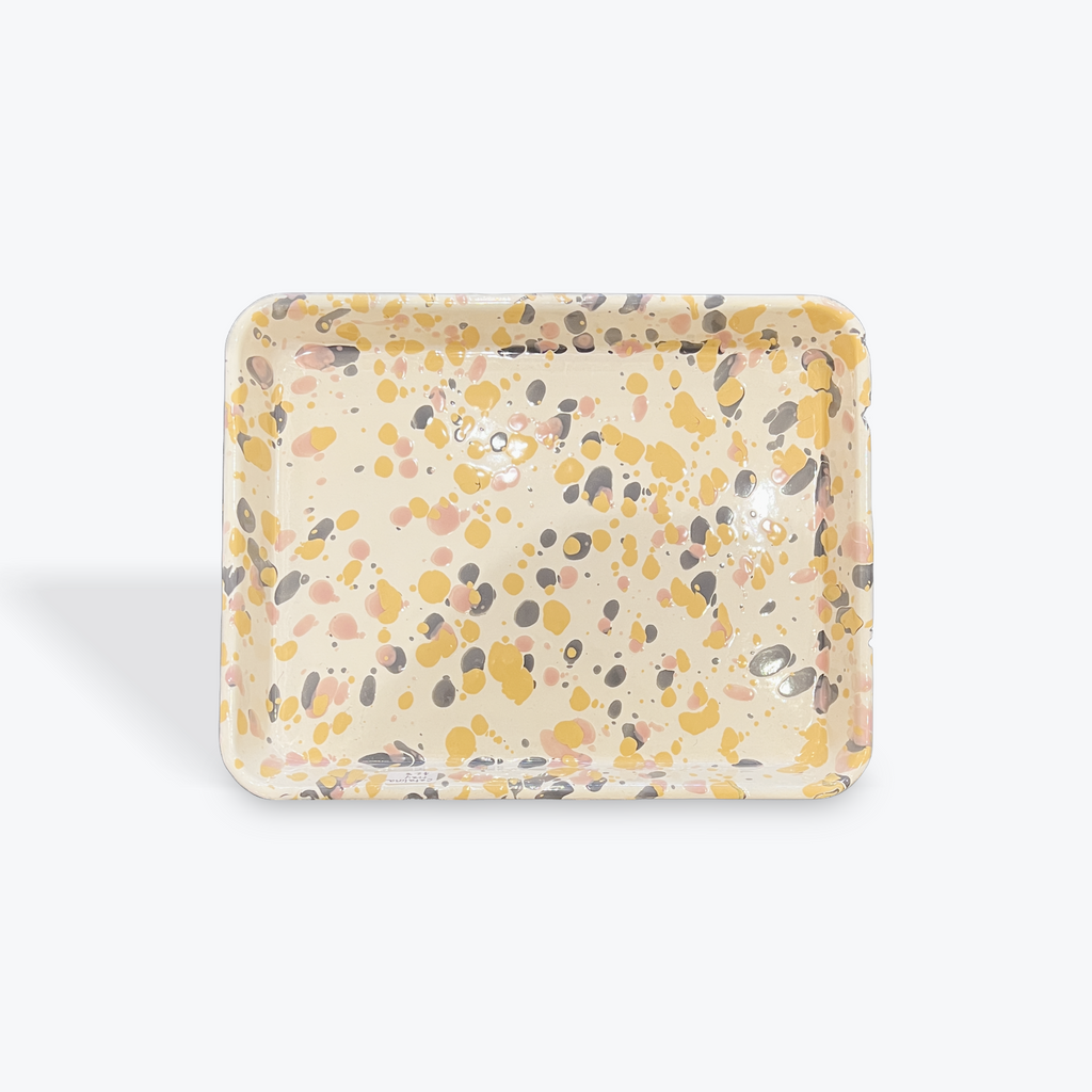 Square enamel dish with speckled pattern on a white background