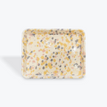 Square enamel dish with speckled pattern on a white background