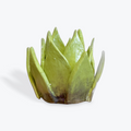 Green ceramic artichoke heart a white background