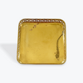 Gold decorative tray with intricate patterns on a white background