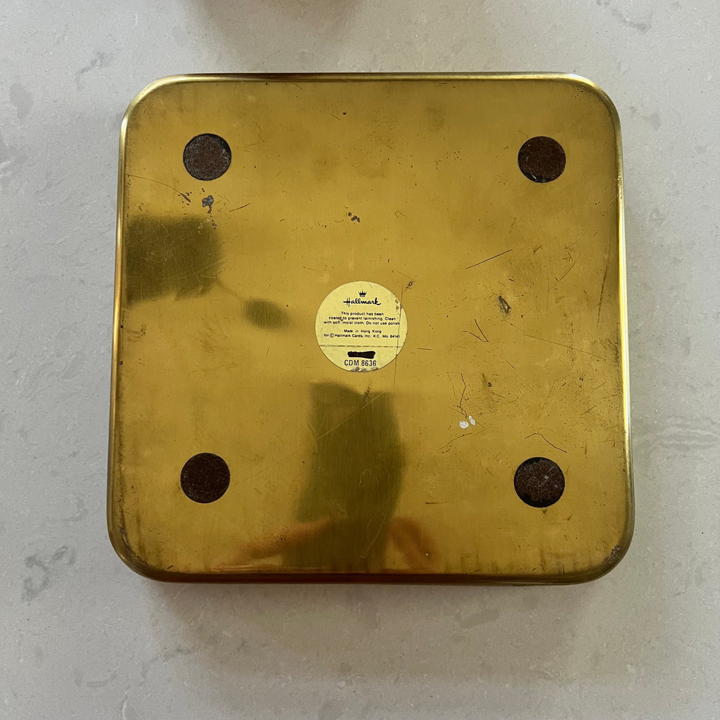 The bottom of a gold tray on a light background.