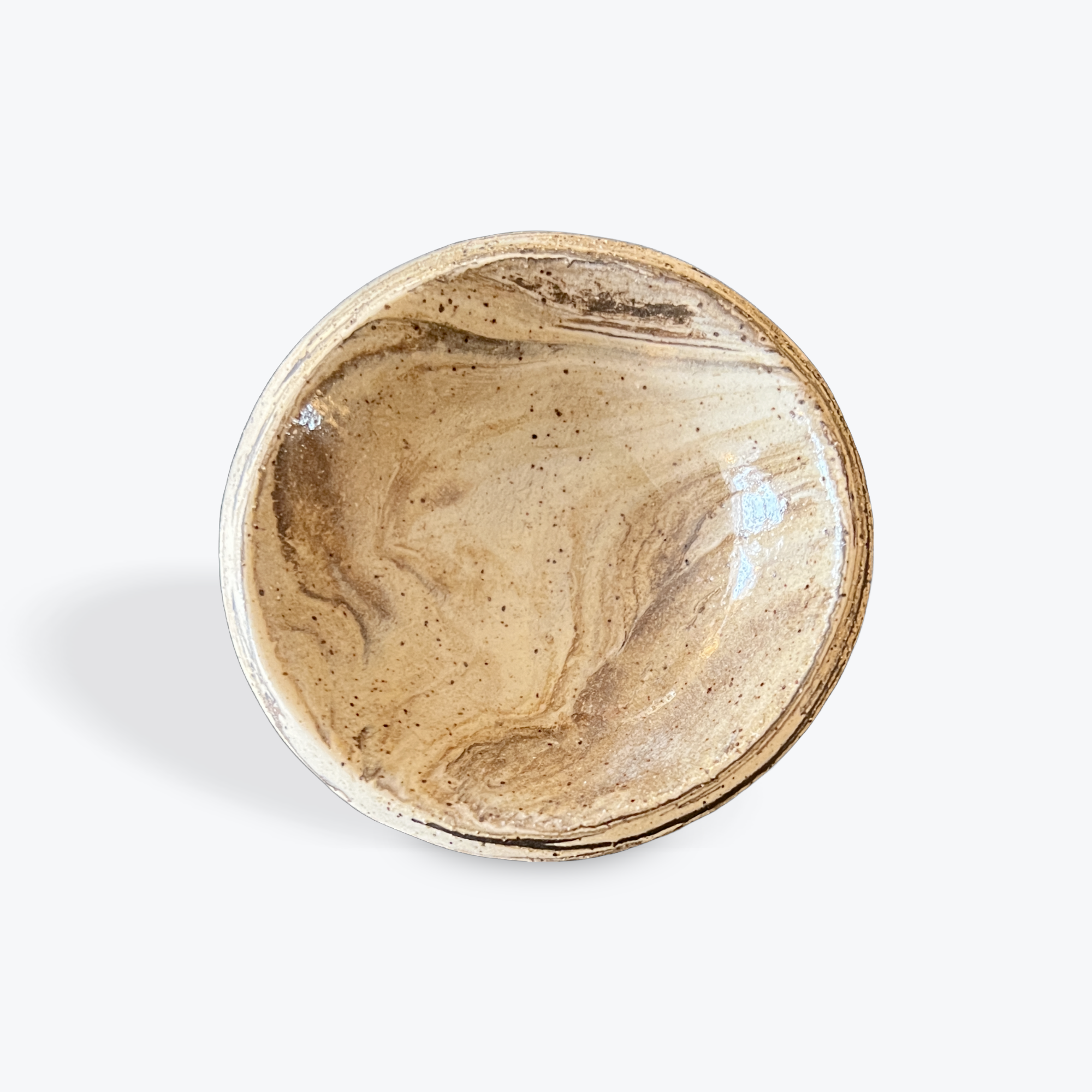 Round ceramic dish with marbled design on a white background