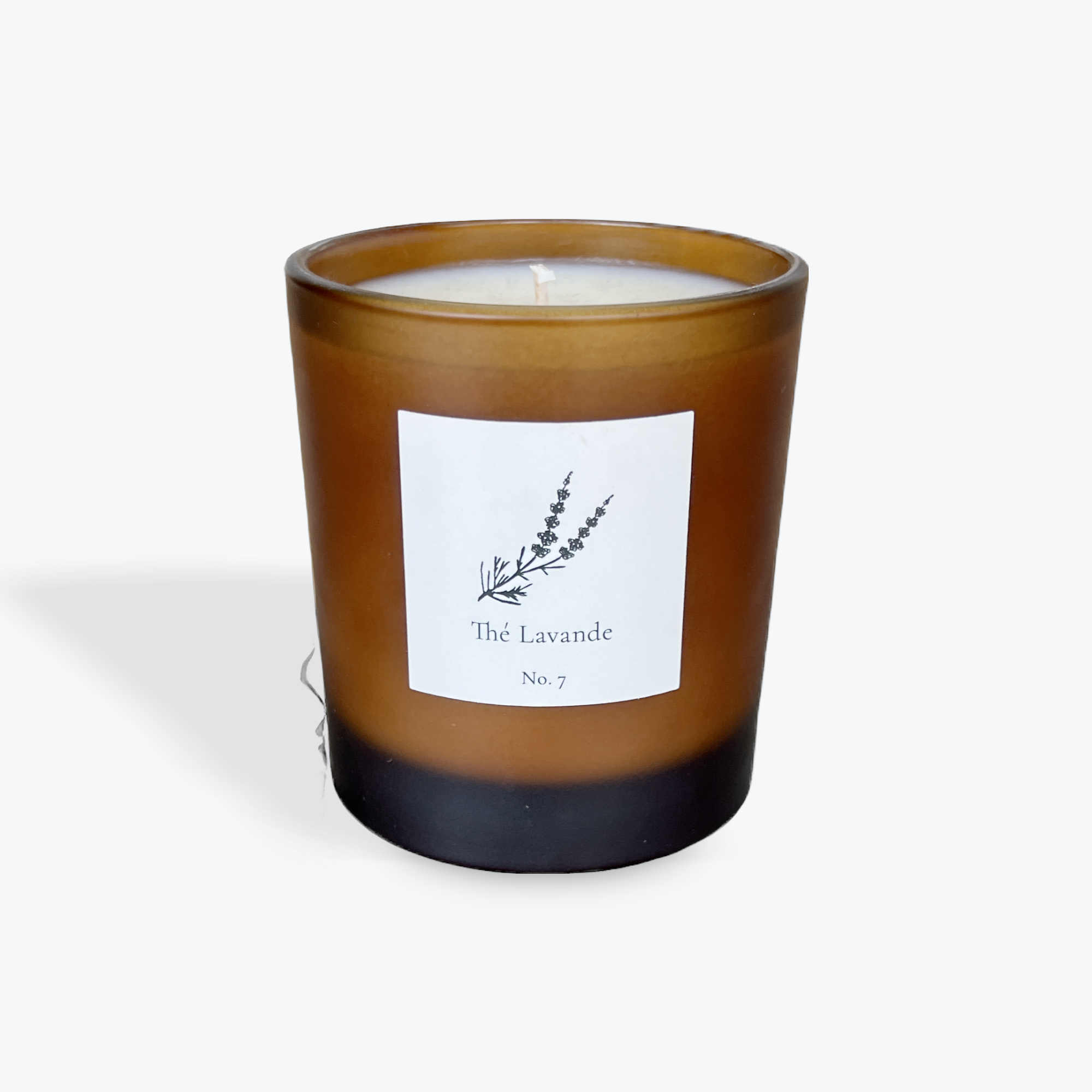 Candle in a brown jar with a label on a white background