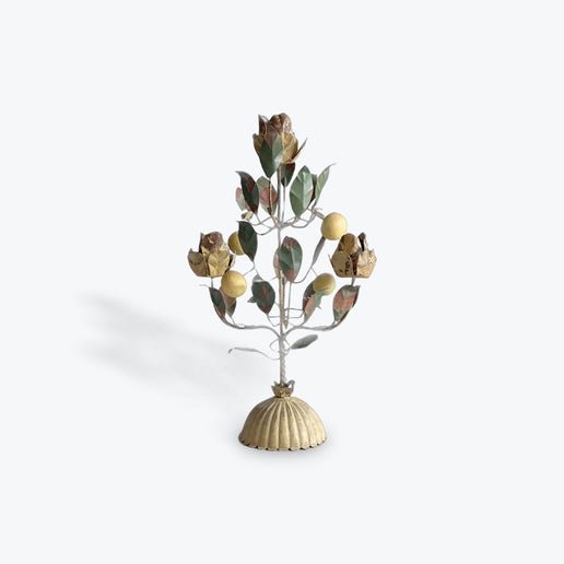 Decorative metal tree with leaves on a white background