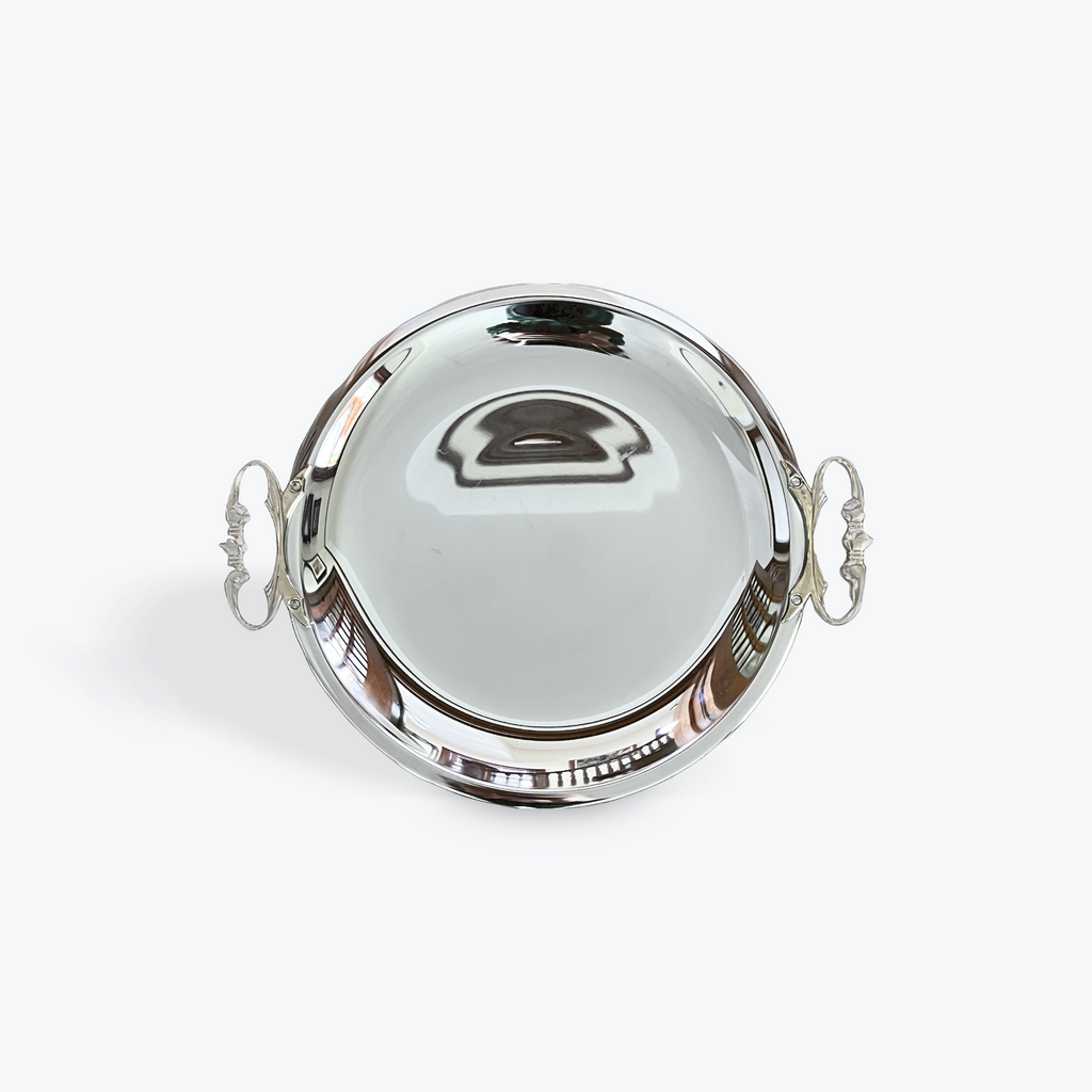 Silver round tray with handles on a white background