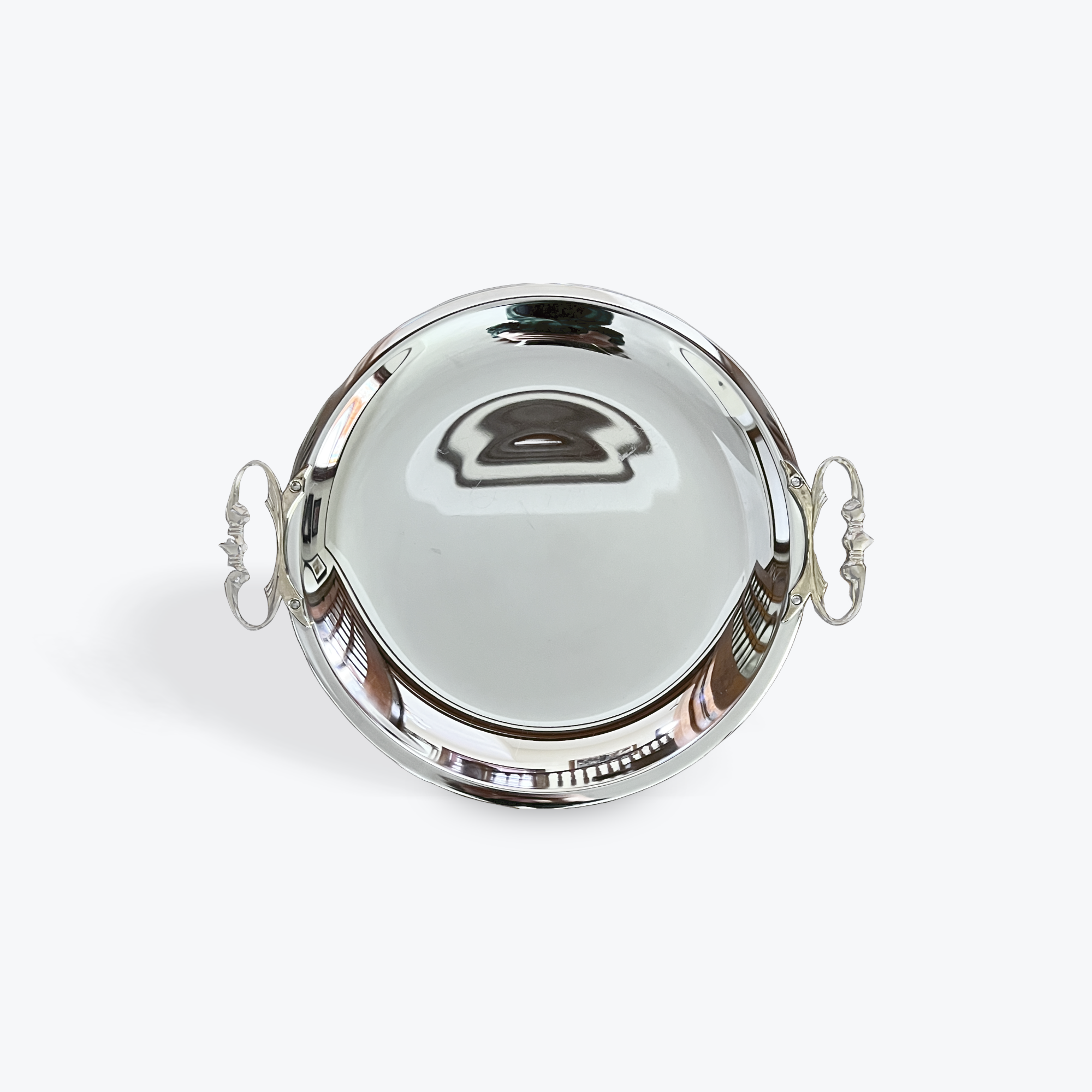Silver round tray with handles on a white background