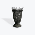 Black wire mesh vase on a white background