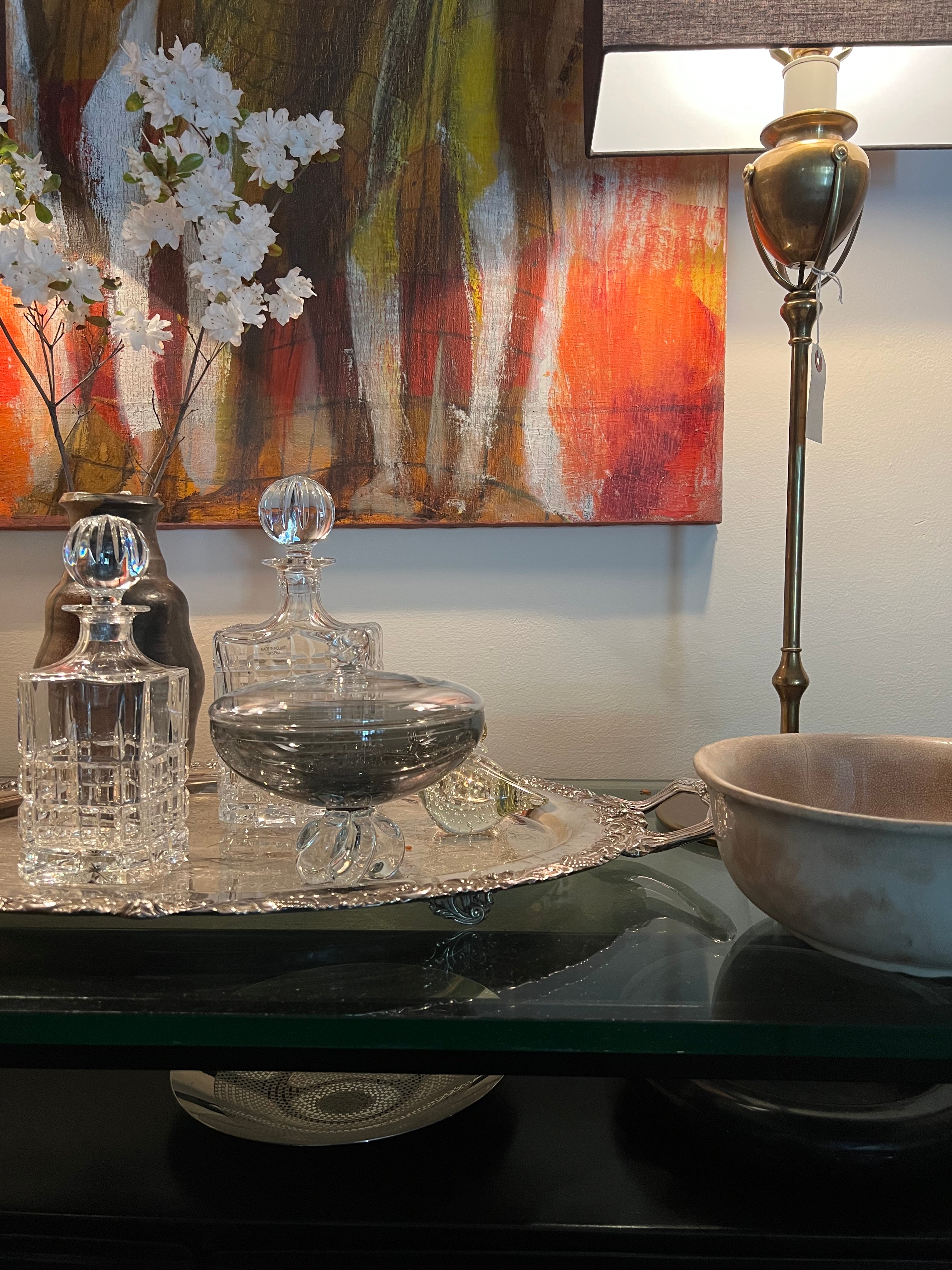 Decorative items on a table with a painting in the background