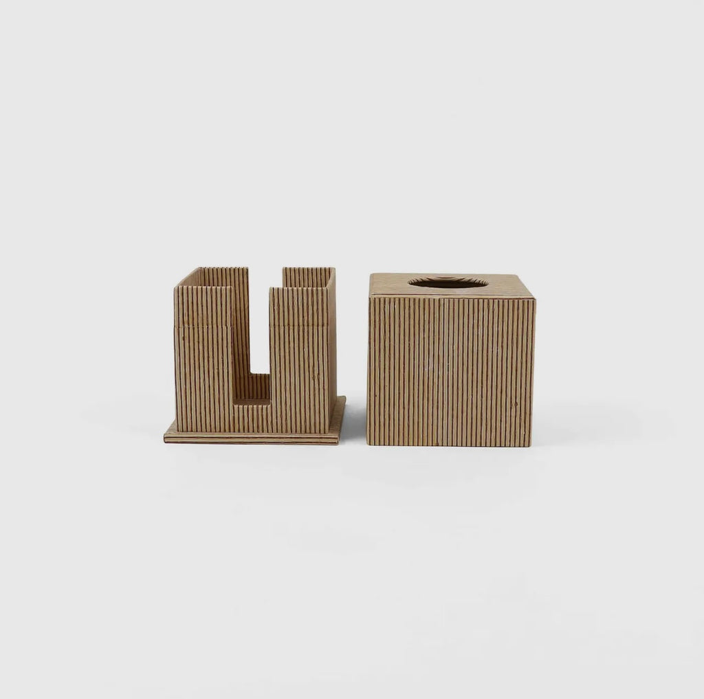 Square block printed tissue box with yellow and maroon pinstripes on a light gray background