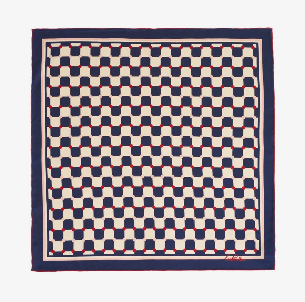 a blue and white checkered scarf with red dots on a white background