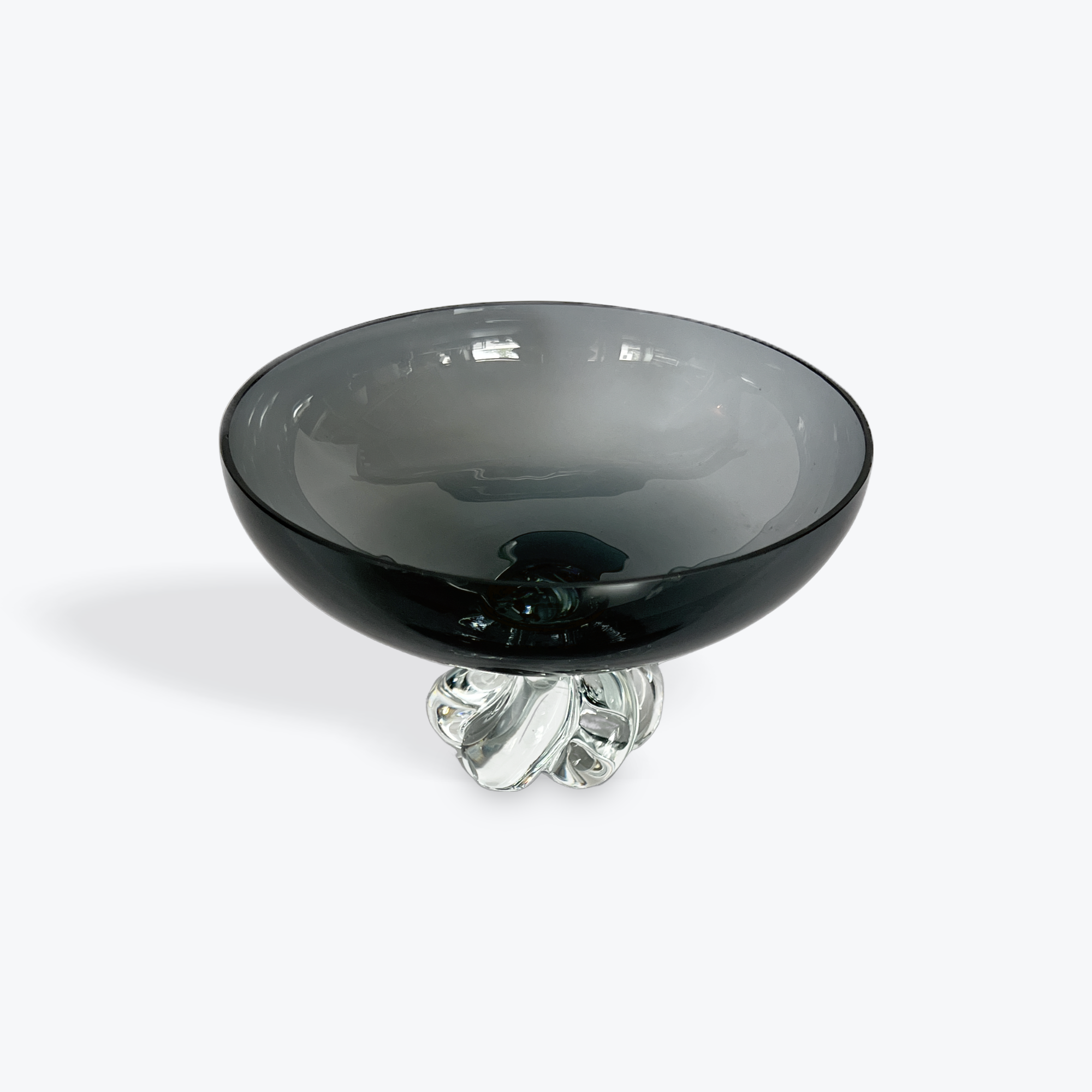 Smoky gray glass bowl with a clear base on a white background