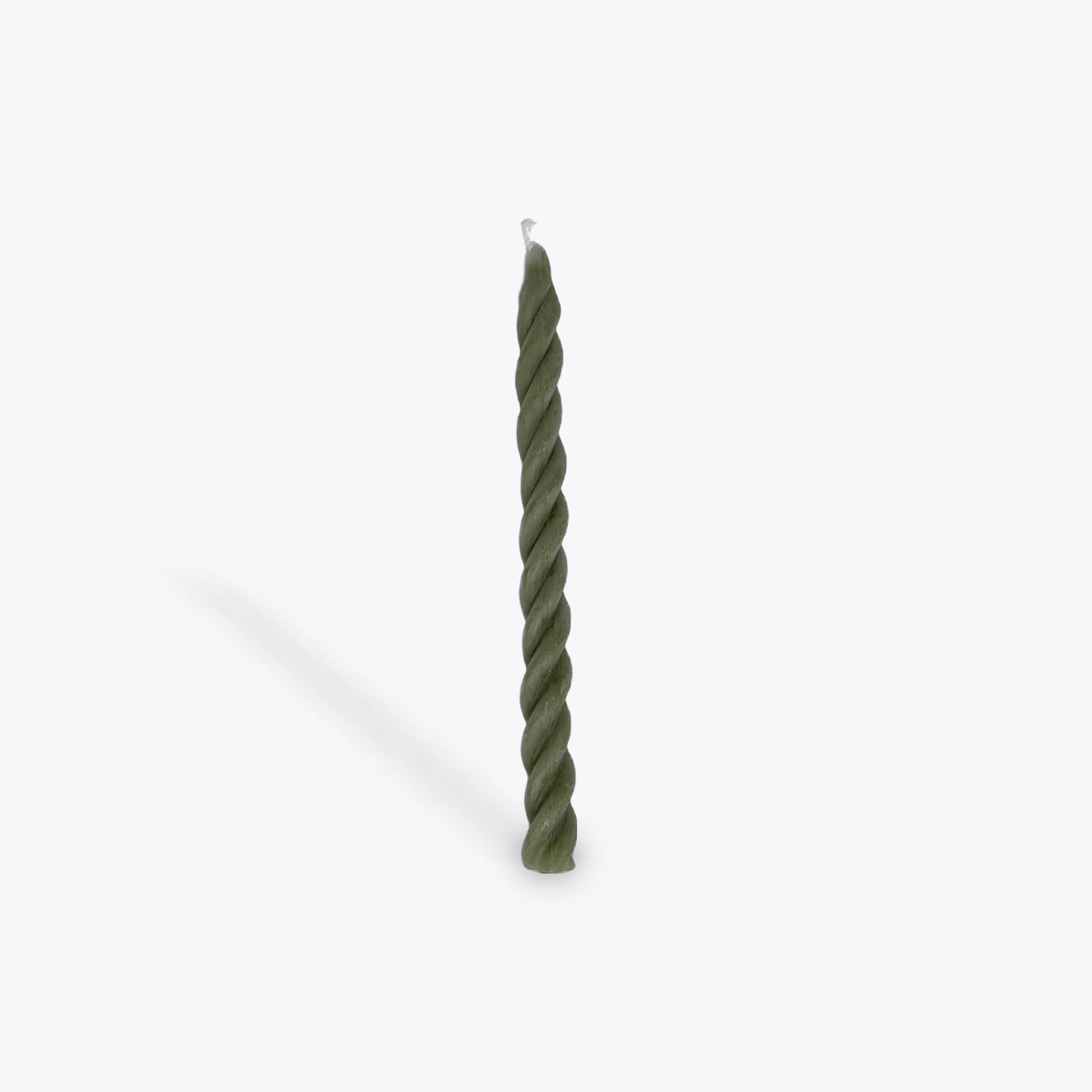 Green twisted candle on a white background