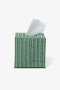 Blue and green striped tissue box with tissues on a white background