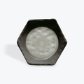Hexagonal ceramic dish with a gray glazed circcle  inset on a white background