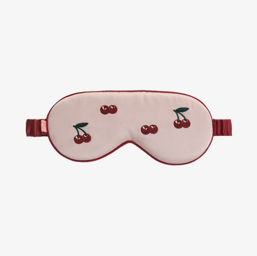 Sleep mask with cherry design on a white background