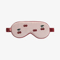 Sleep mask with cherry design on a white background