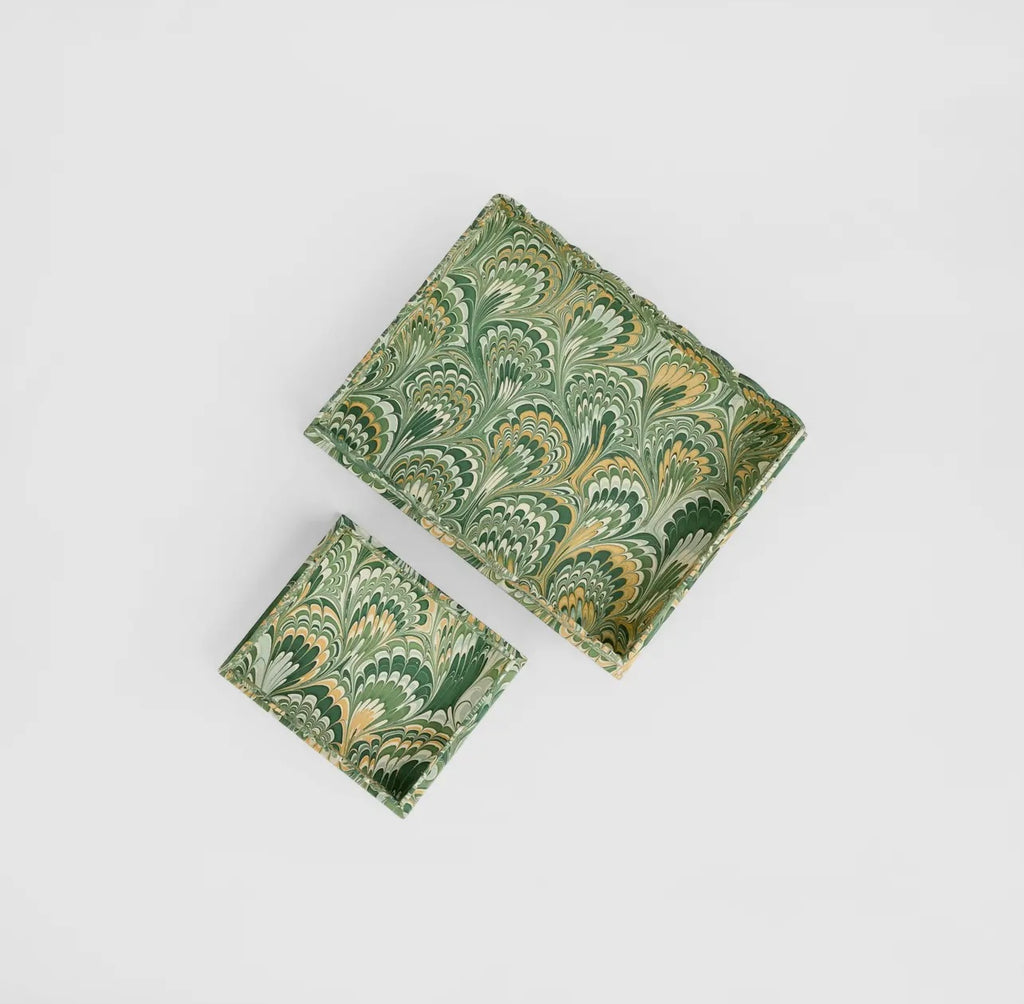 Two green marbled patterned trays on a light gray background