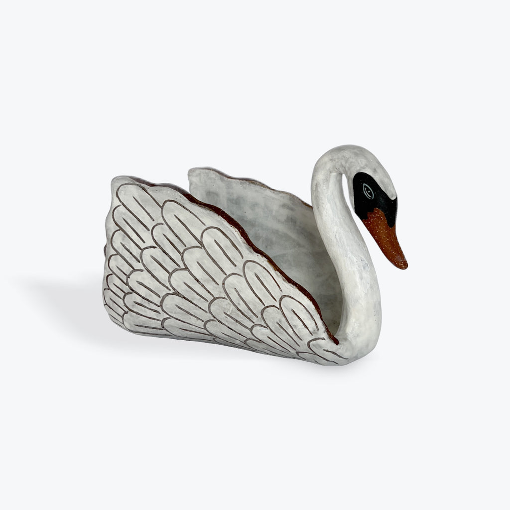 White ceramic swan on a white background
