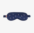 A blue eye mask with moons and stars on a white background.