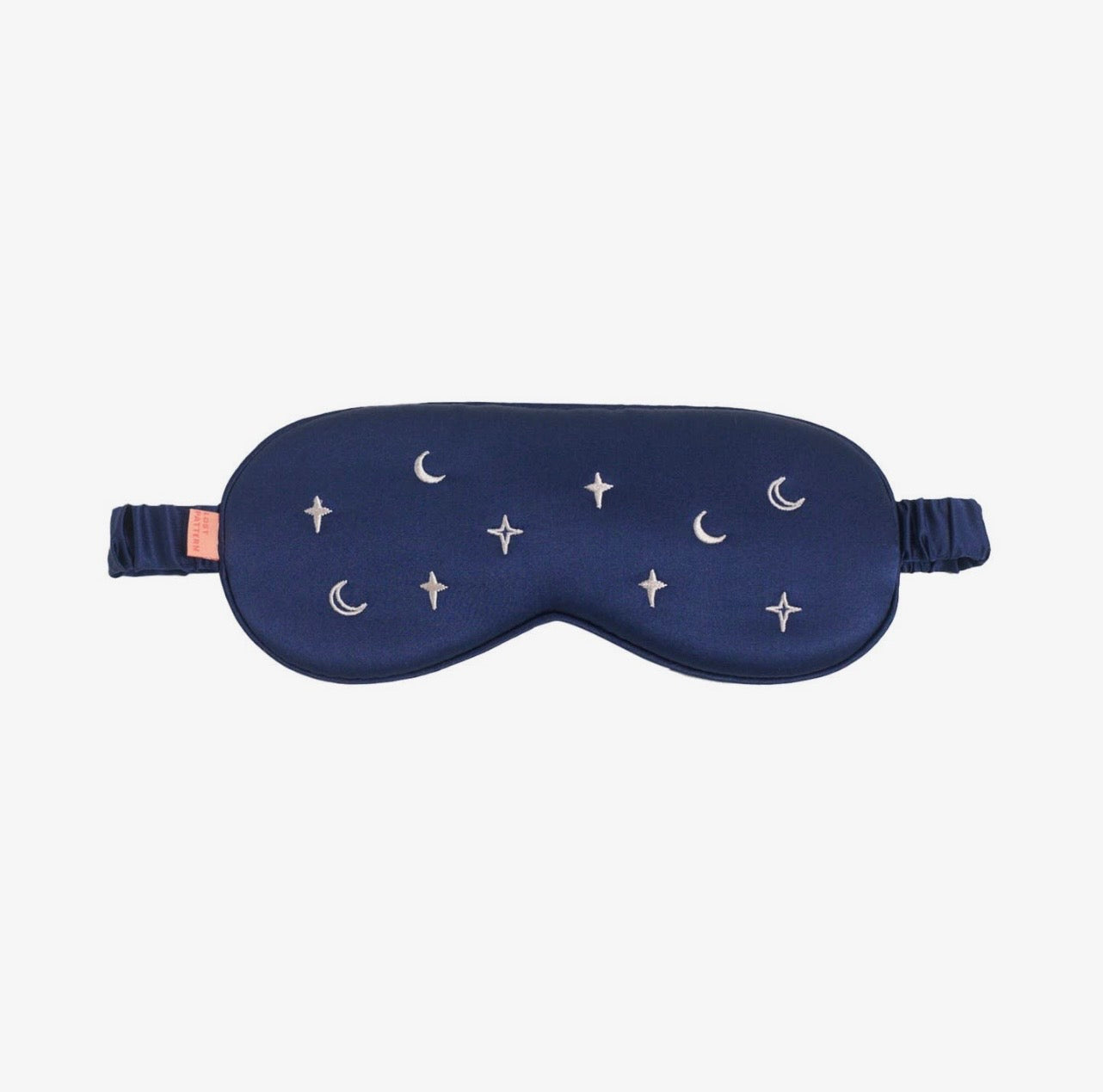 A blue eye mask with moons and stars on a white background.