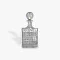 Clear crystal decanter with a  stopper on a white background