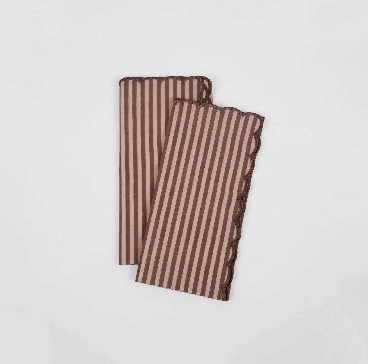 Pair of stripe rose and brown napkins with a scalloped edge on a white background