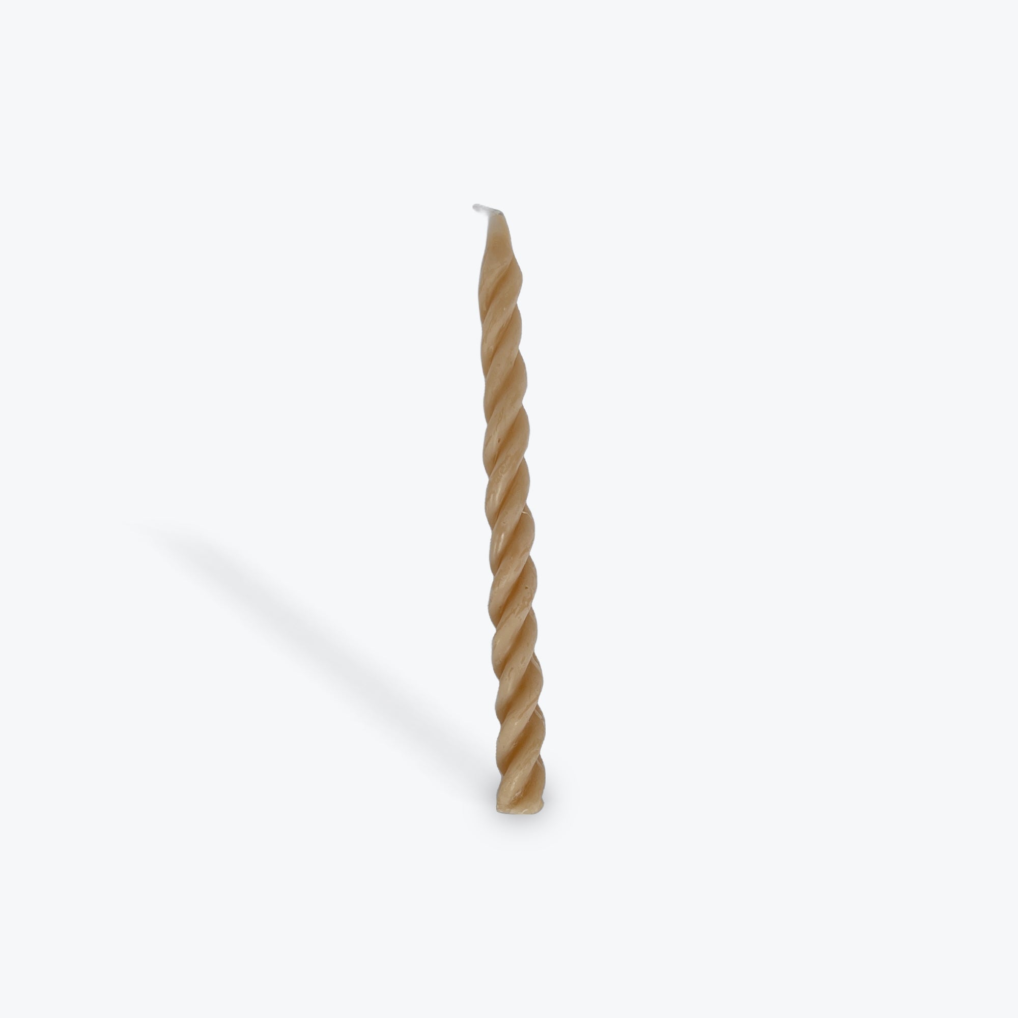 Beige twisted taper candle on a white background