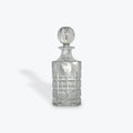 Clear glass decanter with a stopper on a white background
