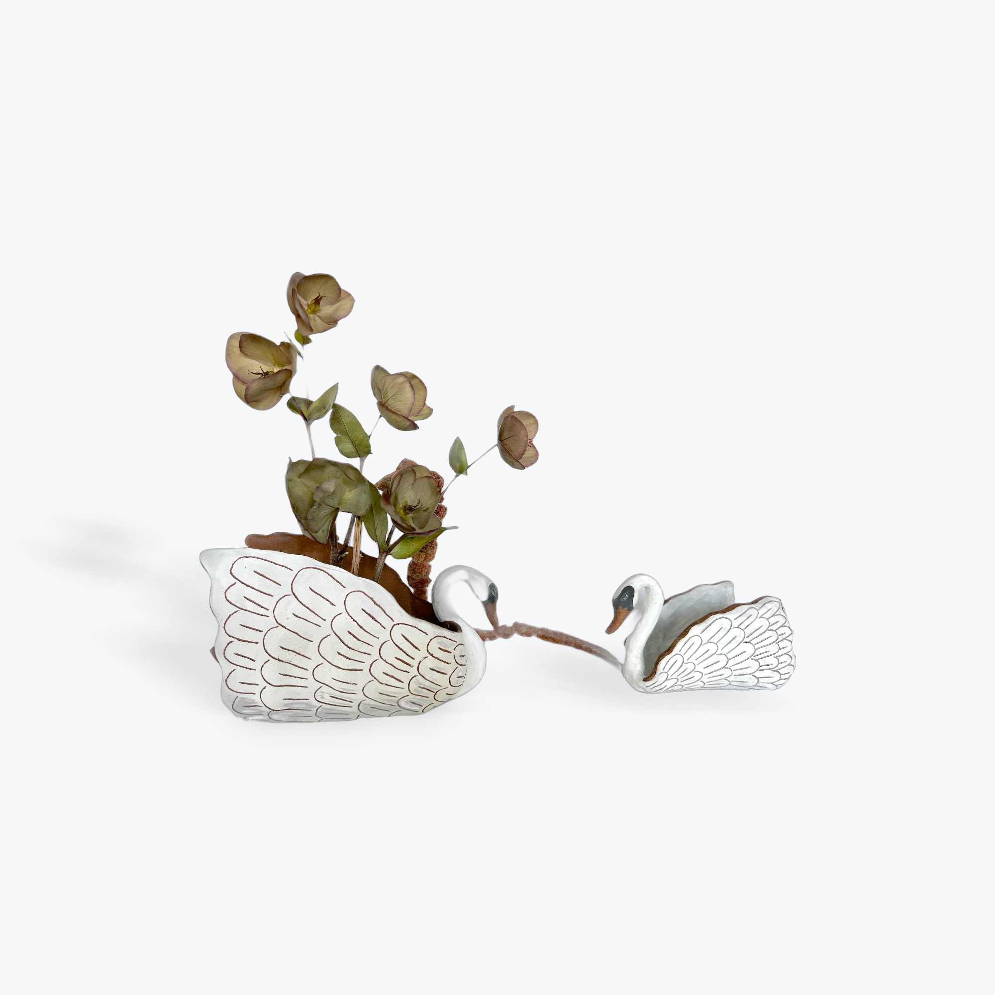 Decorative bird-shaped planter with dried flowers on a white background