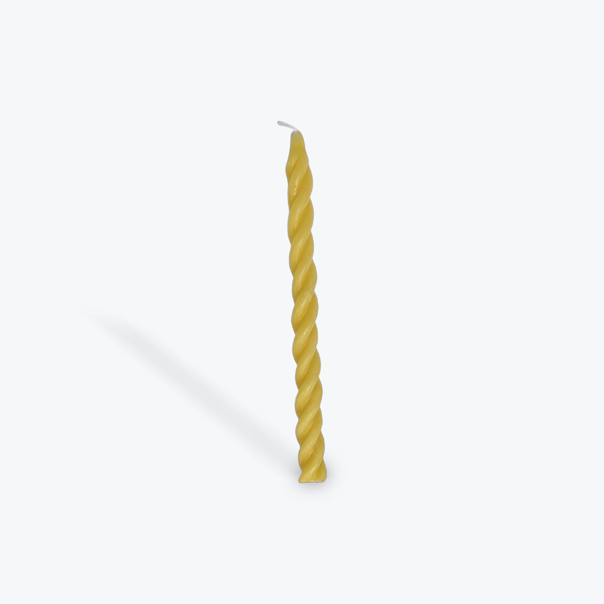 Gold twisted candle on a white background