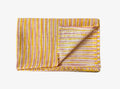 Folded fabric with pink and yellow striped pattern on a white background